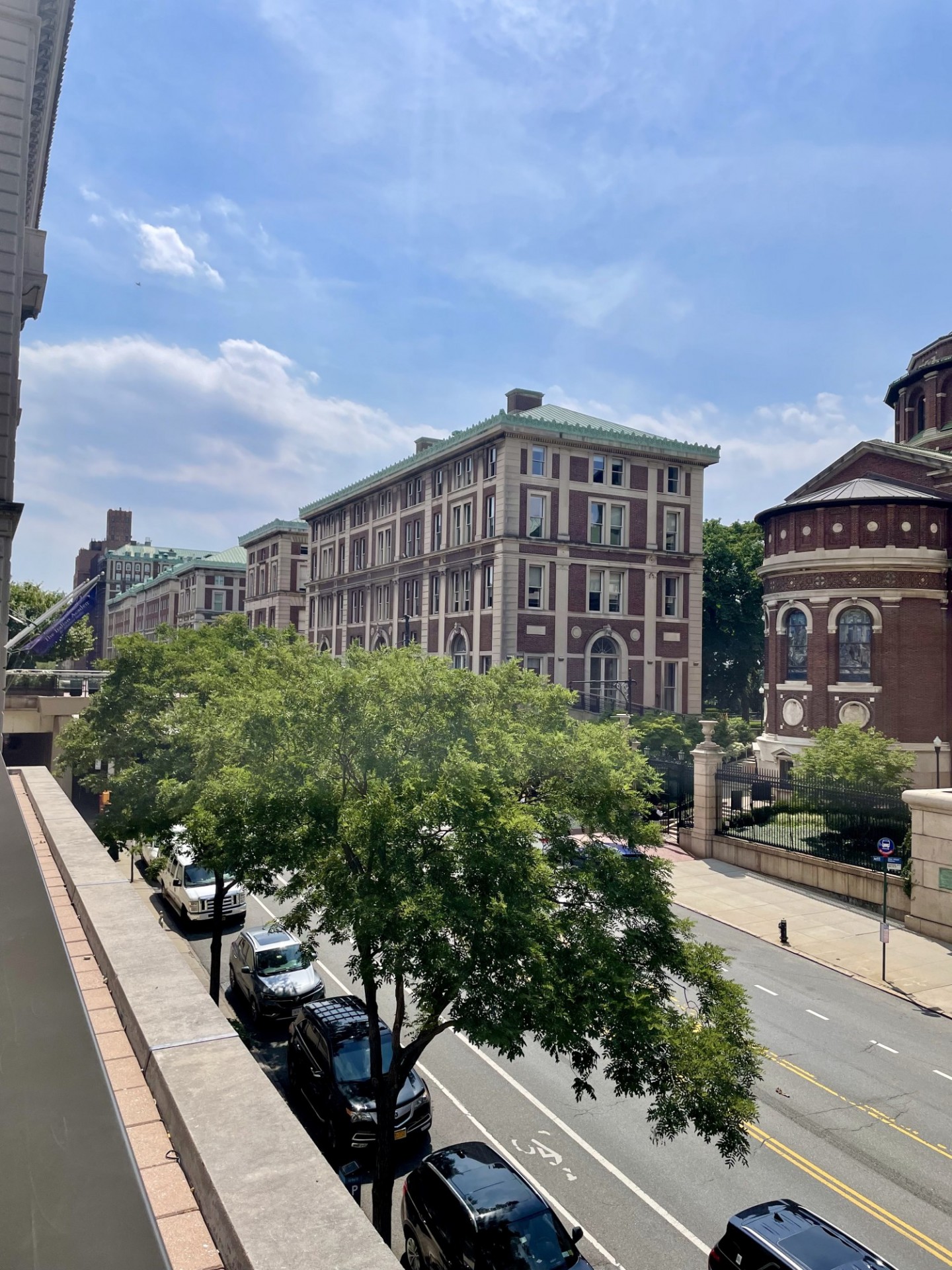 Photograph of campus buildings along Amsterdam Avenue: St. Paul's Chapel, Philosophy Hall and Kent Hall in foreground
