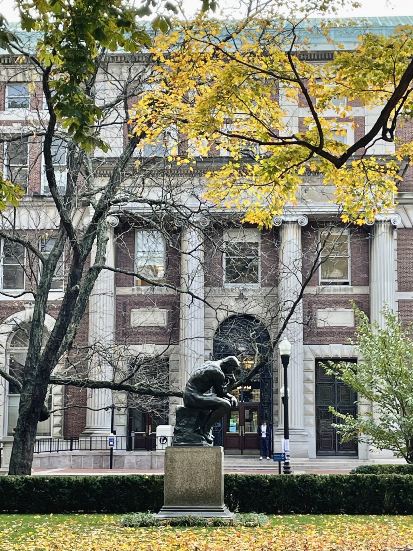 Fall foliage and "The Thinker" in front of Kent Hall