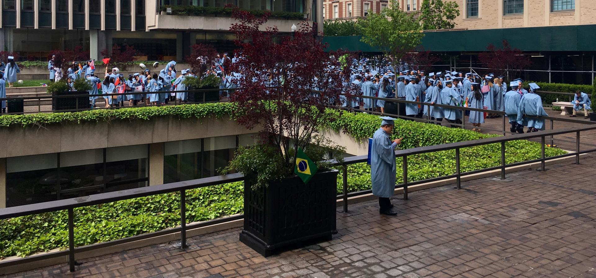 Students in graduation regalia assembling before Commncement